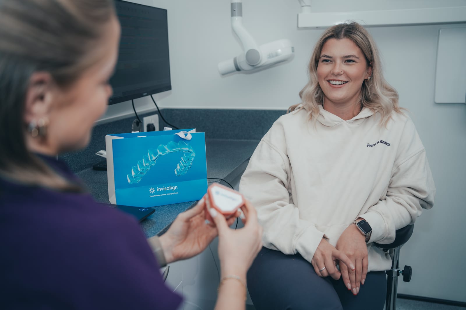 Dentist explaining Invisalign clear aligners to a patient at Abbey Dental Practice, Northwich